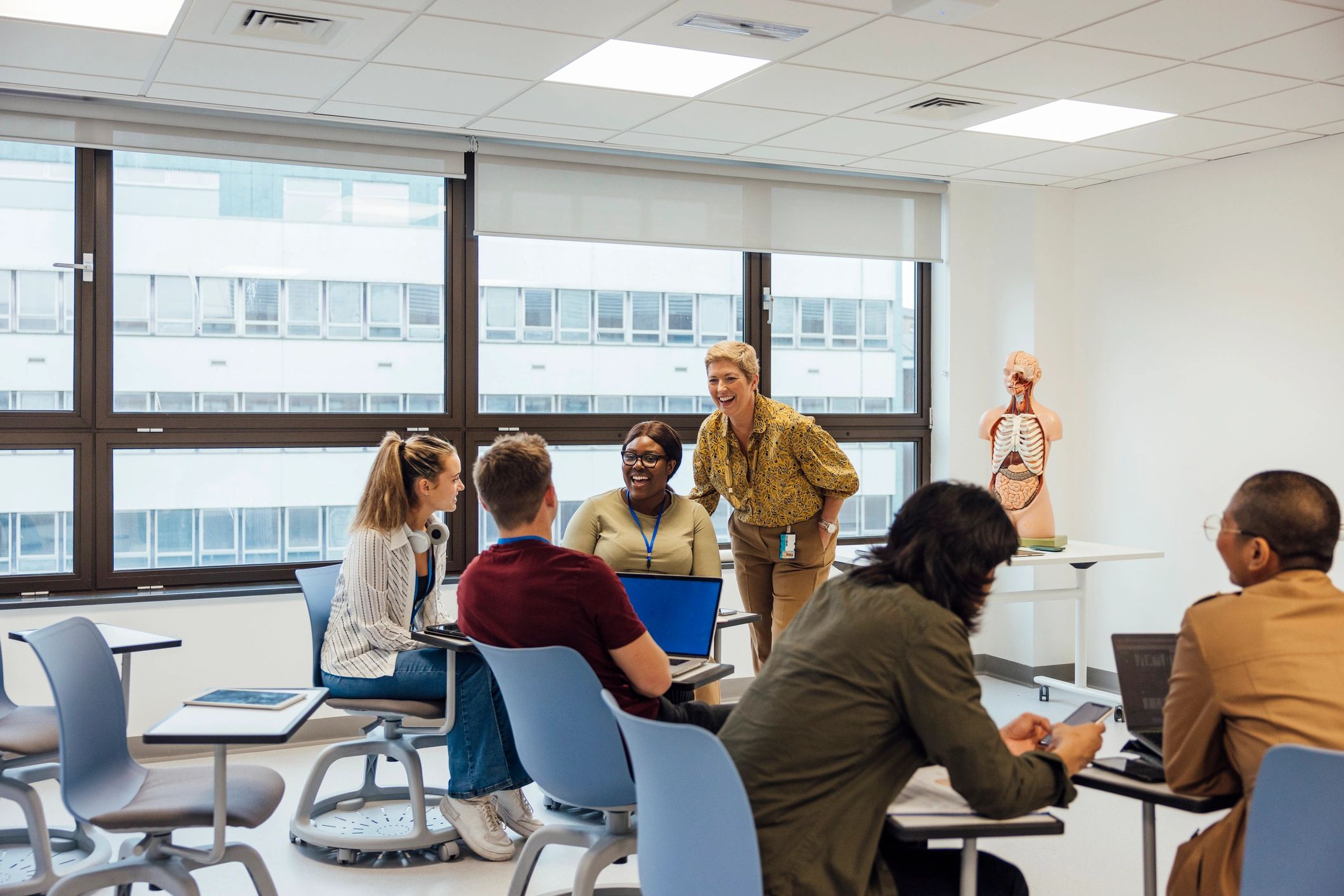Medical students in a hospital classroom collaborating during training